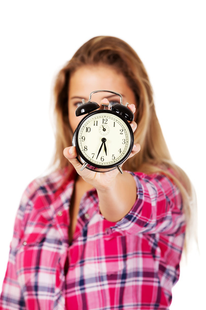 Young blond woman showing alarm clock - Zdjęcie, obraz