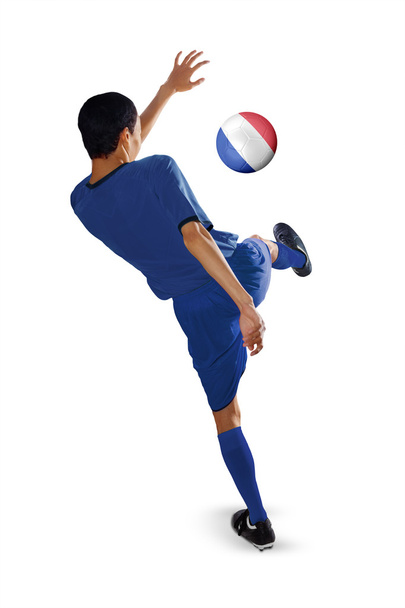 Football player kicks a ball - Zdjęcie, obraz