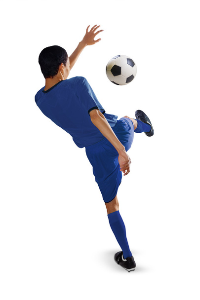 Football player kicks a soccer ball - 写真・画像