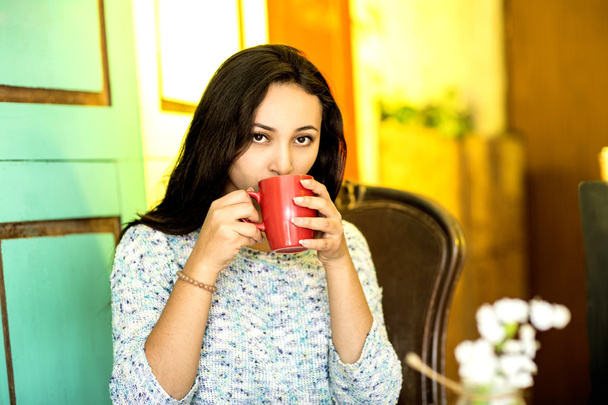 Young woman with a cup of coffee in the morning - Foto, imagen