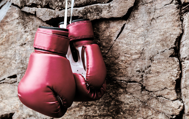 boxing gloves are suspended on a rock - Photo, Image