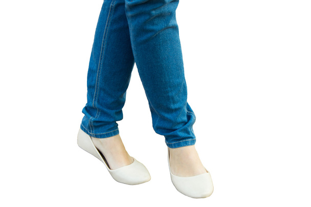 The girl stands, feet in jeans and summer shoes, isolated - Foto, Imagem