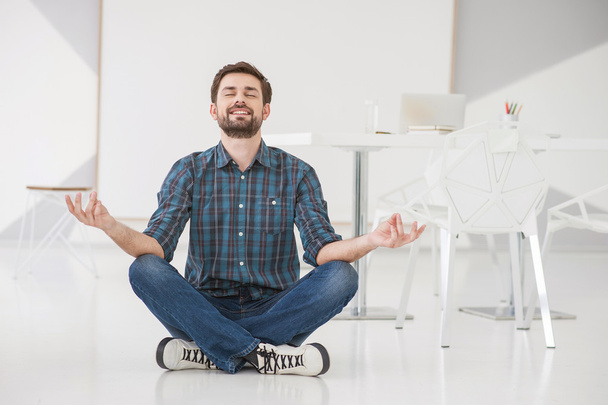 Young business man meditating - Fotó, kép