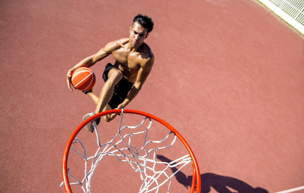 Man playing basketball outdoors - 写真・画像