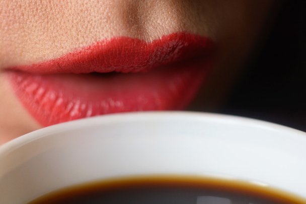 Girl in a white men's shirt drinking coffee from a white cup. Close-up of lips. Macro with blur and soft focus. - Фото, изображение