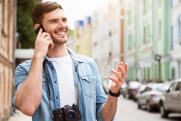 Cheerful man talking on cell phone. - Фото, зображення