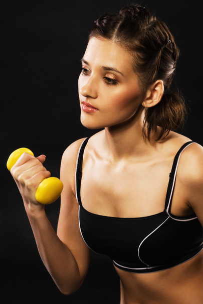 Beautiful woman working out with dumbbells - Photo, Image