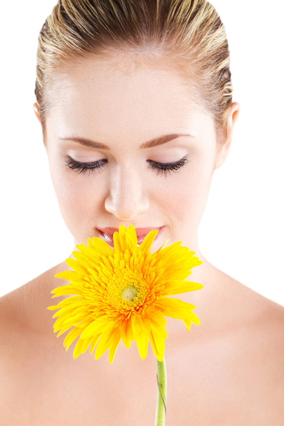 Young woman smelling flower on white - Zdjęcie, obraz