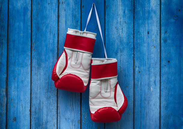 vertical wooden old blue background with boxing gloves - Photo, Image