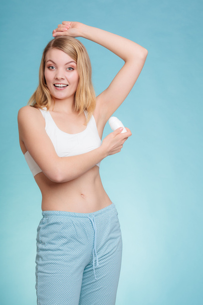 Girl applying stick deodorant in armpit. - Φωτογραφία, εικόνα