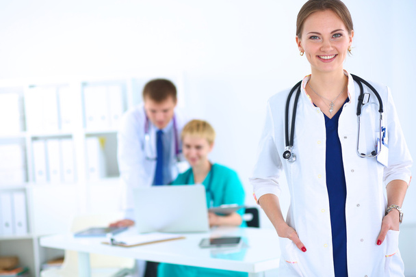 Attractive female doctor in front of medical group - Foto, immagini