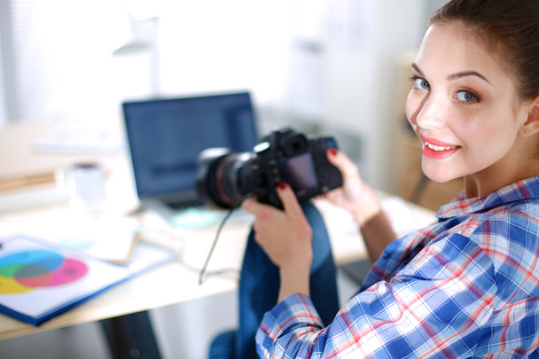 Female photographer sitting on the desk with laptop - Foto, immagini