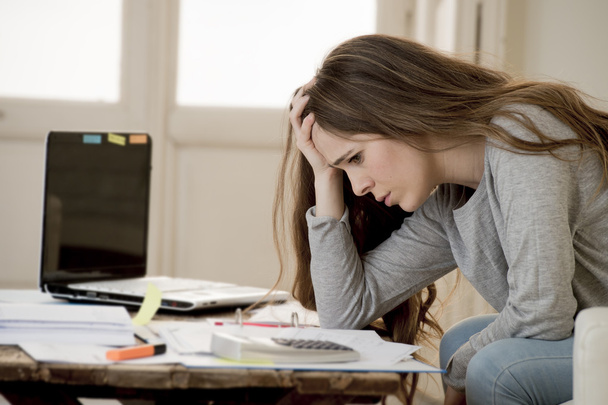 worried woman suffering stress doing domestic accounting paperwork bills and invoices  - Photo, Image