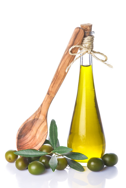 Olive oil bottle and wooden spoon isolated - Foto, imagen