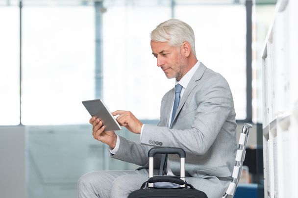 Businessman using tablet at airport - Фото, изображение