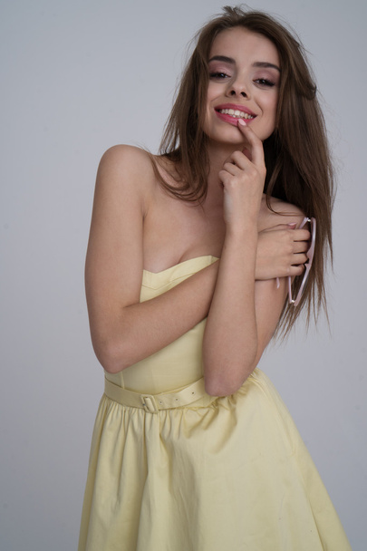 pretty brunette wearing yellow dress - Фото, изображение