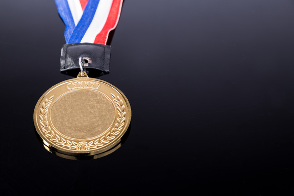 Generic sporting event gold medal with red and blue ribbon - Фото, зображення
