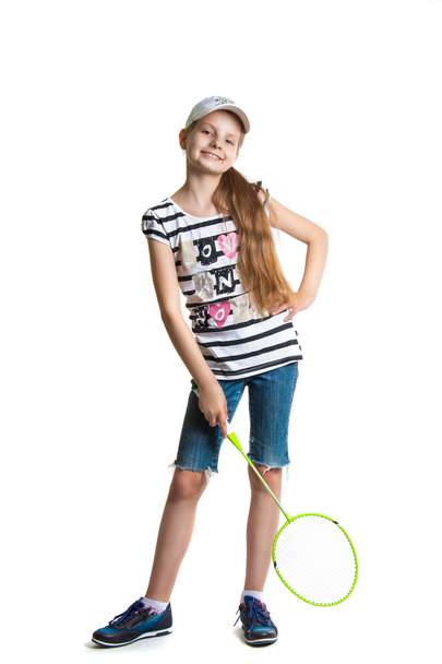 Pretty teen girl plays with a racket for a badminton on a white background. - Fotografie, Obrázek