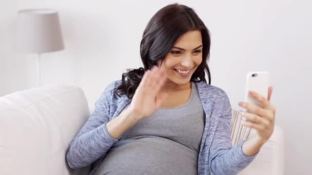 pregnant woman in smartphone video chat at home - Footage, Video
