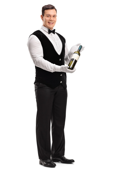 Waiter holding a bottle of white wine  - Foto, afbeelding