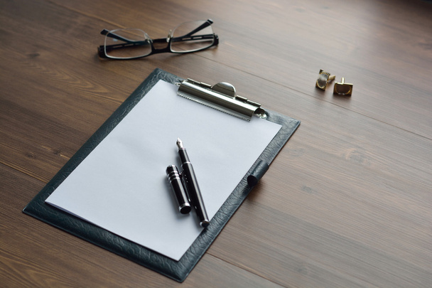 Business accessories on desktop: notebook, diary, fountain pen, cufflinks, glasses. Selective focus - Fotó, kép