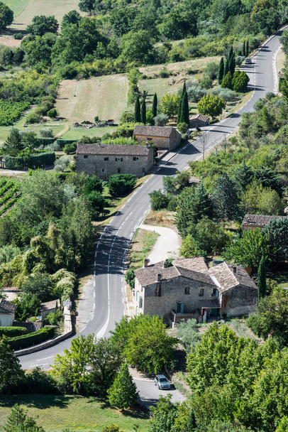 Modern twisted asphaltic road across a small village of Provence - Photo, Image