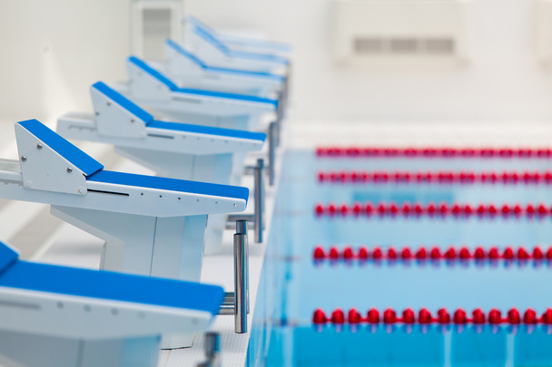 Starting blocks and lanes in a swimming pool - Fotografie, Obrázek