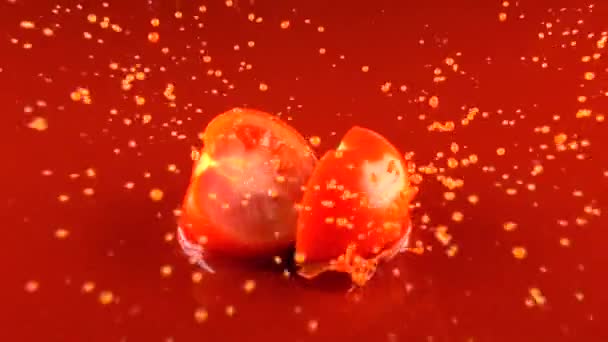 Red tomato falls into tomato juice and dividing into halves. Super slow motion - Materiaali, video