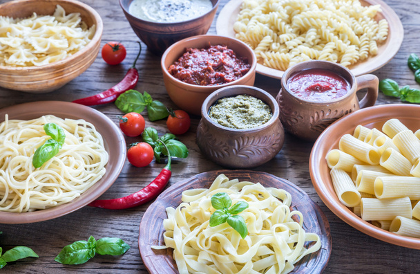 Pasta with different kinds of sauce on the wooden background - Foto, Bild