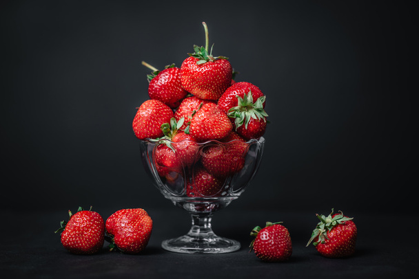Ripe juicy strawberries in a glass on a dark background - Zdjęcie, obraz