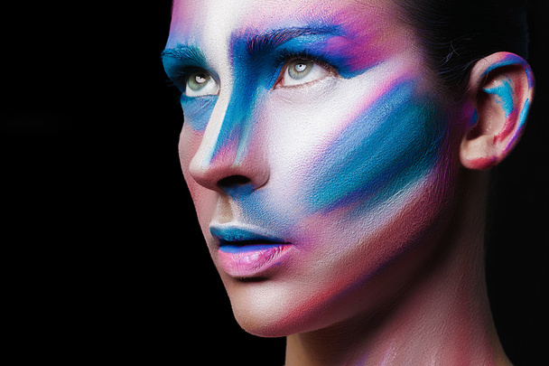Beautiful fashion woman with bright color face art and body art. Paint on face. Creative portrait - Фото, зображення