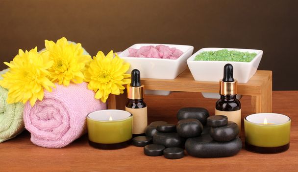 Spa setting on wooden table on brown background - Foto, imagen
