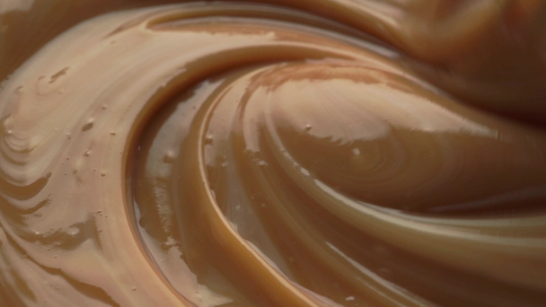 Mixing dense chocolate cream with egg whisk. Macro video - Footage, Video