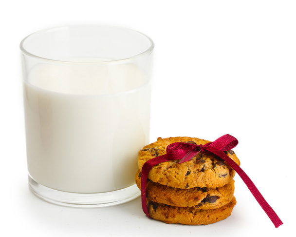 Glass of milk and chocolate chips cookies with red ribbon isolated on white - Foto, Bild