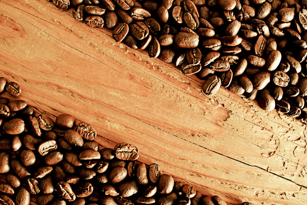 Coffee beans on wooden surface - Valokuva, kuva