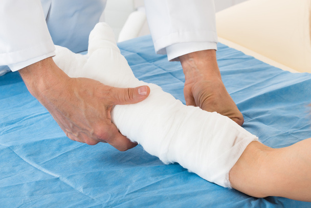 Doctor Bandaging Patient Hand - Фото, изображение