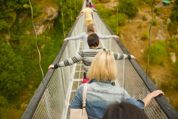 people follow each other on bridge - Photo, Image