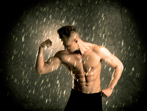 Fitness guy with weight showing muscles - 写真・画像