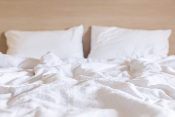 White bedding sheets and pillow, Messy bed concept - Photo, image