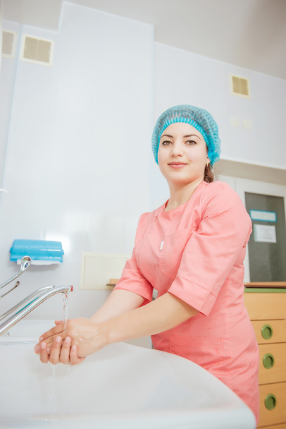 female surgeon putting on gloves before surgery - Valokuva, kuva