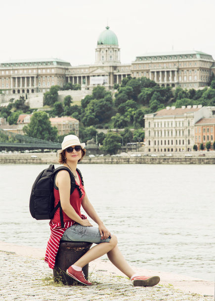 Joyful tourist woman posing with Buda castle on the Danube river - Photo, Image