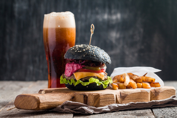 Homemade burger with black bun - Photo, Image
