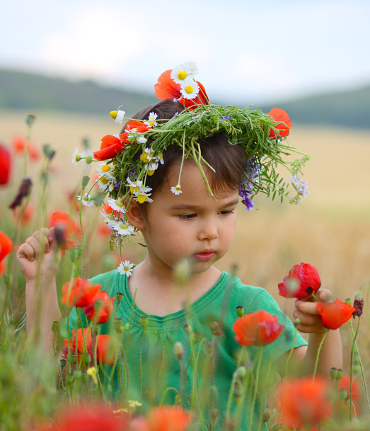 Happy cute child girl on poppies field. Happy children. Healthy lifestyle - Photo, Image