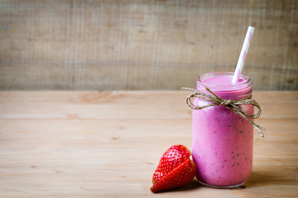 Smoothie, pink juice on the grey  background. - Фото, изображение