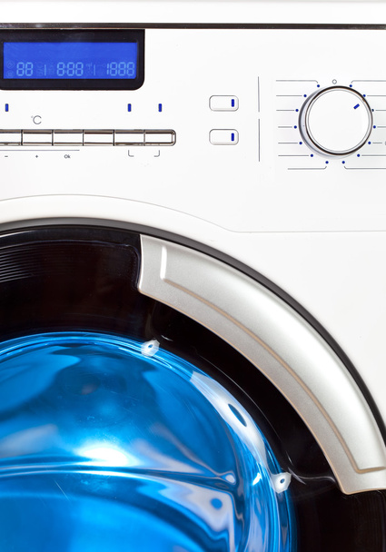 The washing machine - a close up of the display, the manhole and a choice of program - 写真・画像
