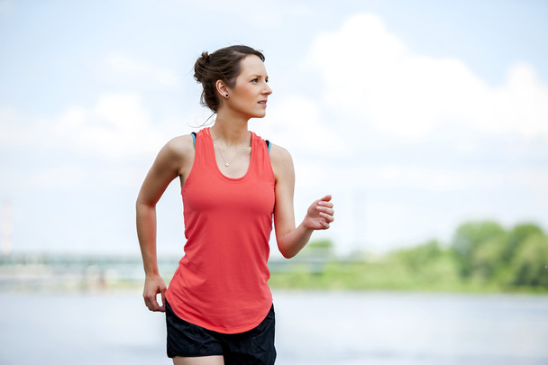Fit woman jogging by the river. - Photo, Image