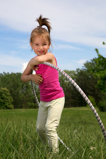 Smiling Little Girl With Hula Hoop Enjoying Beautiful Spring Day In The Park - Фото, изображение