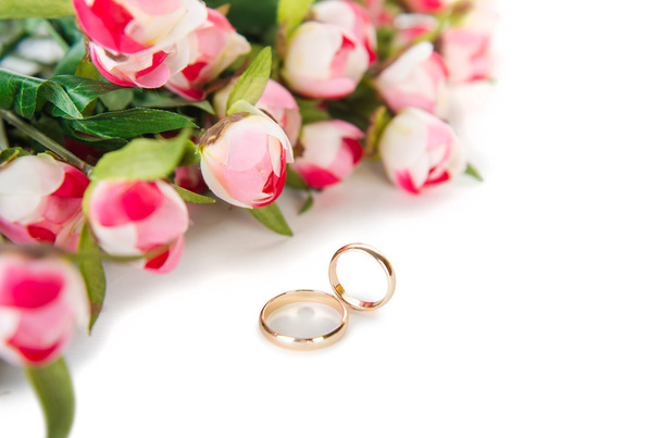 Wedding rings and flowers isolated on white background - 写真・画像