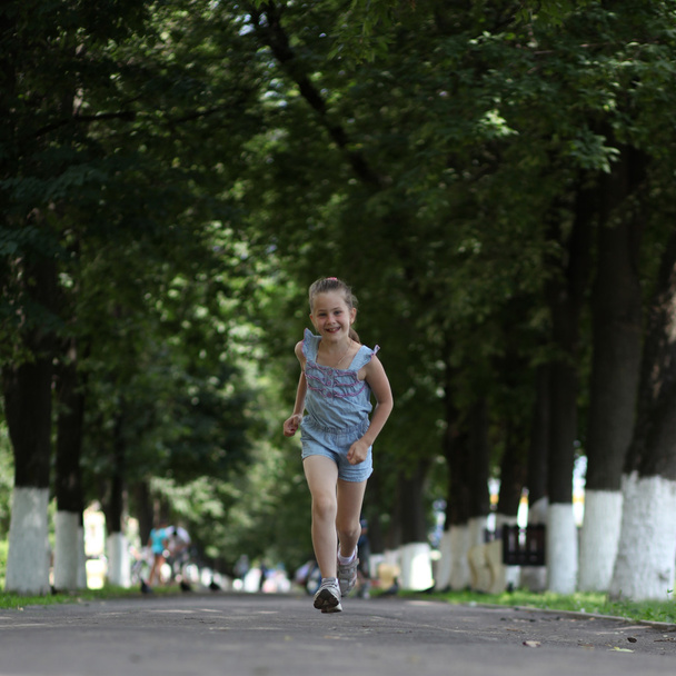 Little girl running on the park - Photo, image