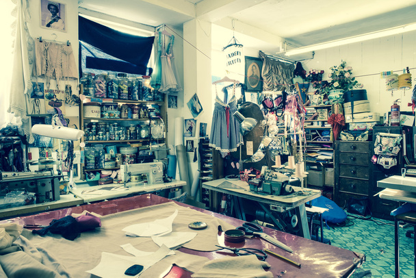 Inside a Tailoring Shop with Cutting Table in the Foreground - 写真・画像